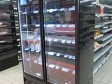 two refrigerators that are sitting in the middle of a store