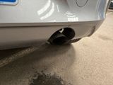 a close up of a car exhaust pipe on the back of a car