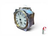 a silver clock with roman numerals on it