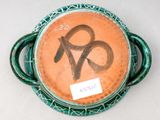 a green plate with a brown and black design on it