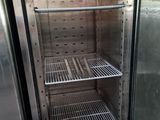 an empty refrigerator with a fan in the door