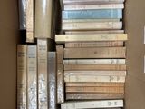 a box full of books sitting on top of each other