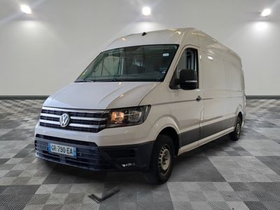 the white van is parked in a large room with checkered floor