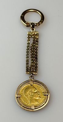 an image of a keychain with a gold coin on it