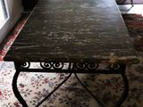 a table with a marble top in a living room