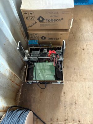 a box that has a printer on top of it next to some boxes