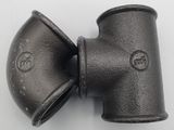 a close up of an iron pipe fitting on a white surface