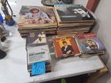 a lot of records on a table in a room