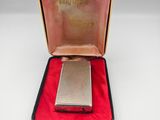 an antique silver cigarette case with a red velvet lining