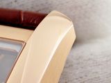 a close up of a wrist watch with a brown leather band