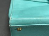 a close up of a blue purse on a table