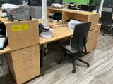 an image of an office cubicle with a lot of clutter on the desks