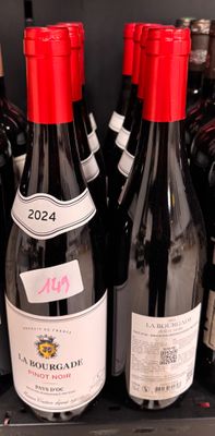 many bottles of wine sitting on a shelf in a store