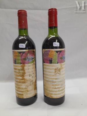 two bottles of wine sitting next to each other on a table