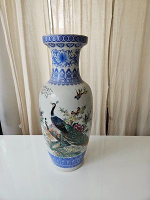 a blue and white vase sitting on a white table
