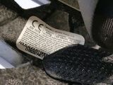 a pair of black shoes and a newspaper on the ground