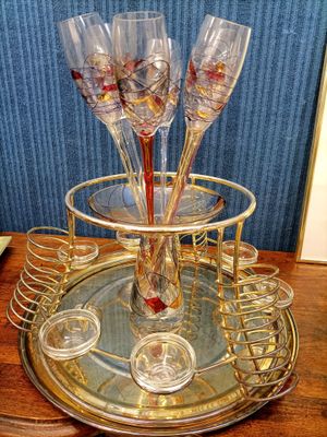 four wine glasses sitting on a tray on a table