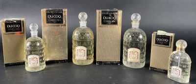 six bottles of liquor are lined up in a row on a table