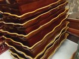 a stack of plates sitting on a table next to a lamp