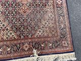 rug on the floor with fringes on top of it