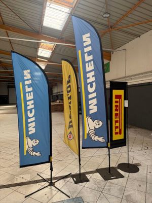 two blue and yellow flags on display in a building