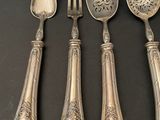 four spoons and two spoons are sitting on a table