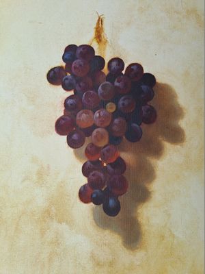 un tableau représentant une grappe de raisin accrochée à un mur
