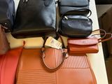 a lot of purses that are on a table