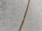 a close up of a gold necklace on a mannequin mannequin mannequin mannequin mannequin mannequin mannequin manne