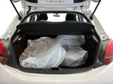 a white car with a trunk full of bags in it