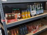 a lot of bottles and cans on the shelves