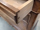 a wooden dresser with a drawer on top of it