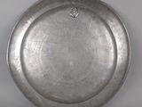 a silver plate with a heart on it on a table