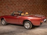 an image of a red convertible car parked in a garage