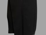 a black skirt hanging on a clothes rack on a gray background