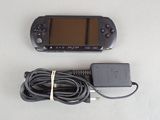 a game console and a charger on a table