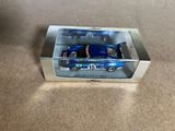a close up of a toy car in a box on a carpet