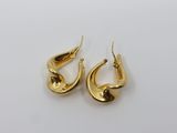 a pair of gold plated earrings on a white background