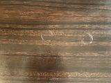 a close up of a wooden table with a clock on it