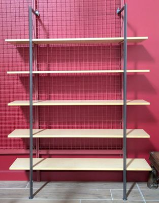 a red wall with a metal shelf and a red wall