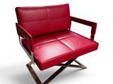 the red leather chair is sitting on a metal frame