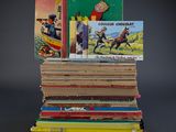 several children ' s books stacked on top of each other on a table