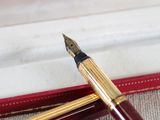a fountain pen sitting on top of an open book