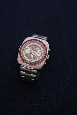 a close up of a watch on a black surface