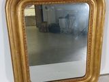 a mirror hanging on a wall in a room