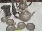 a lot of silver items on a table with a price tag