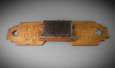 a wooden comb with a black bristles on it