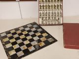 two books and a chess board sitting on a table