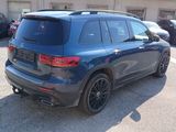 the rear end of a blue mercedes suv parked in a parking lot