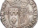 a close up of a coin with a coat of arms on it
